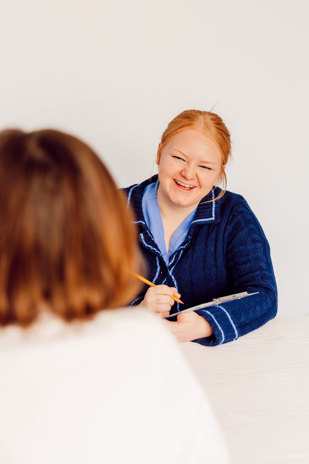 Riverside Psychology staff member with a clipboard during a patient session
