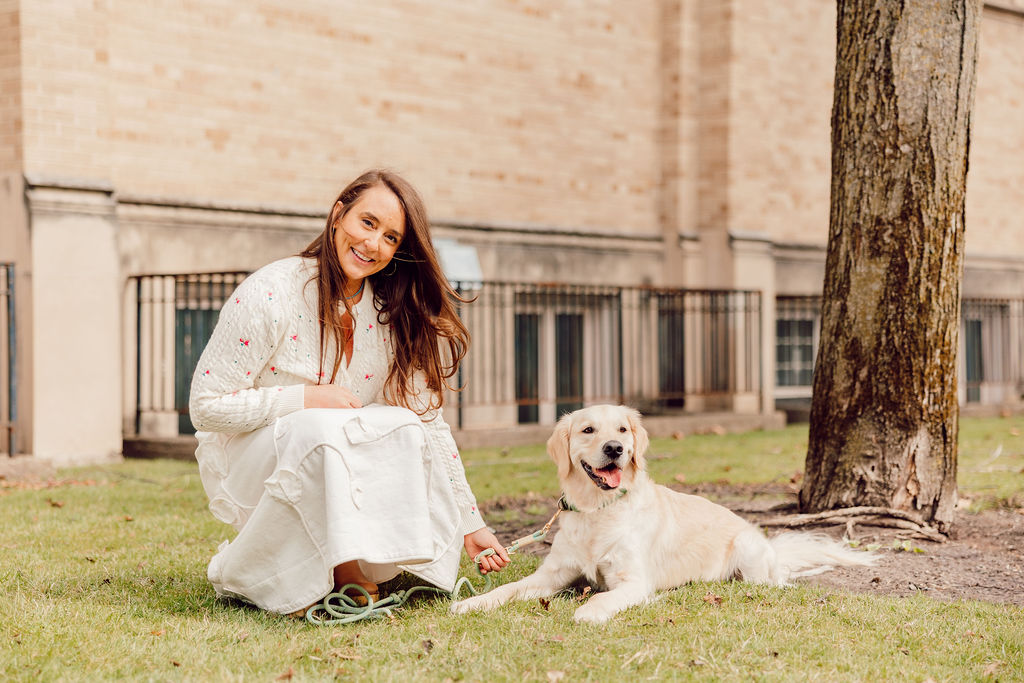 Dr. Megan Baldassarre outdoors with a golden retriever