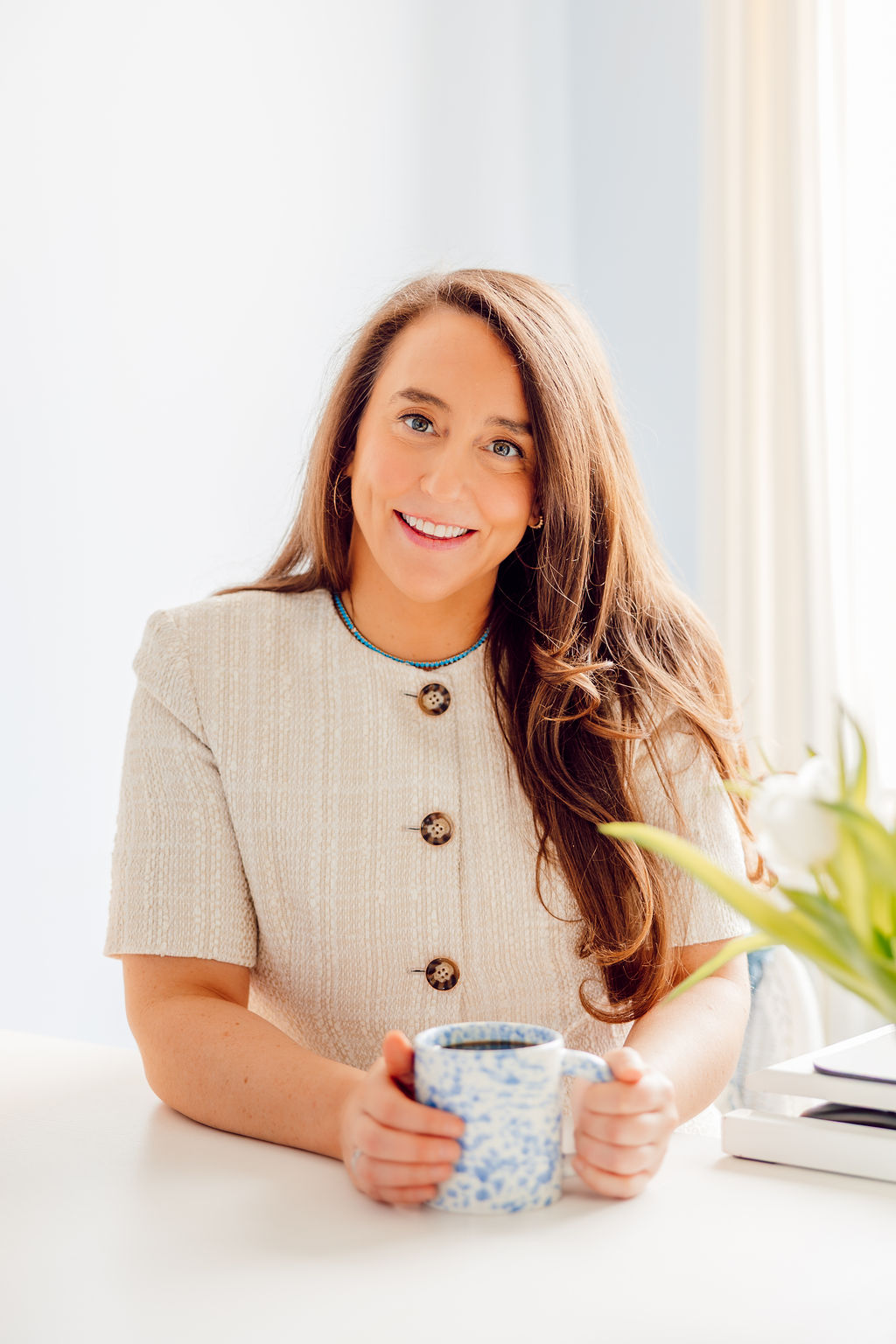 Dr. Megan Baldassarre holding a mug at her desk