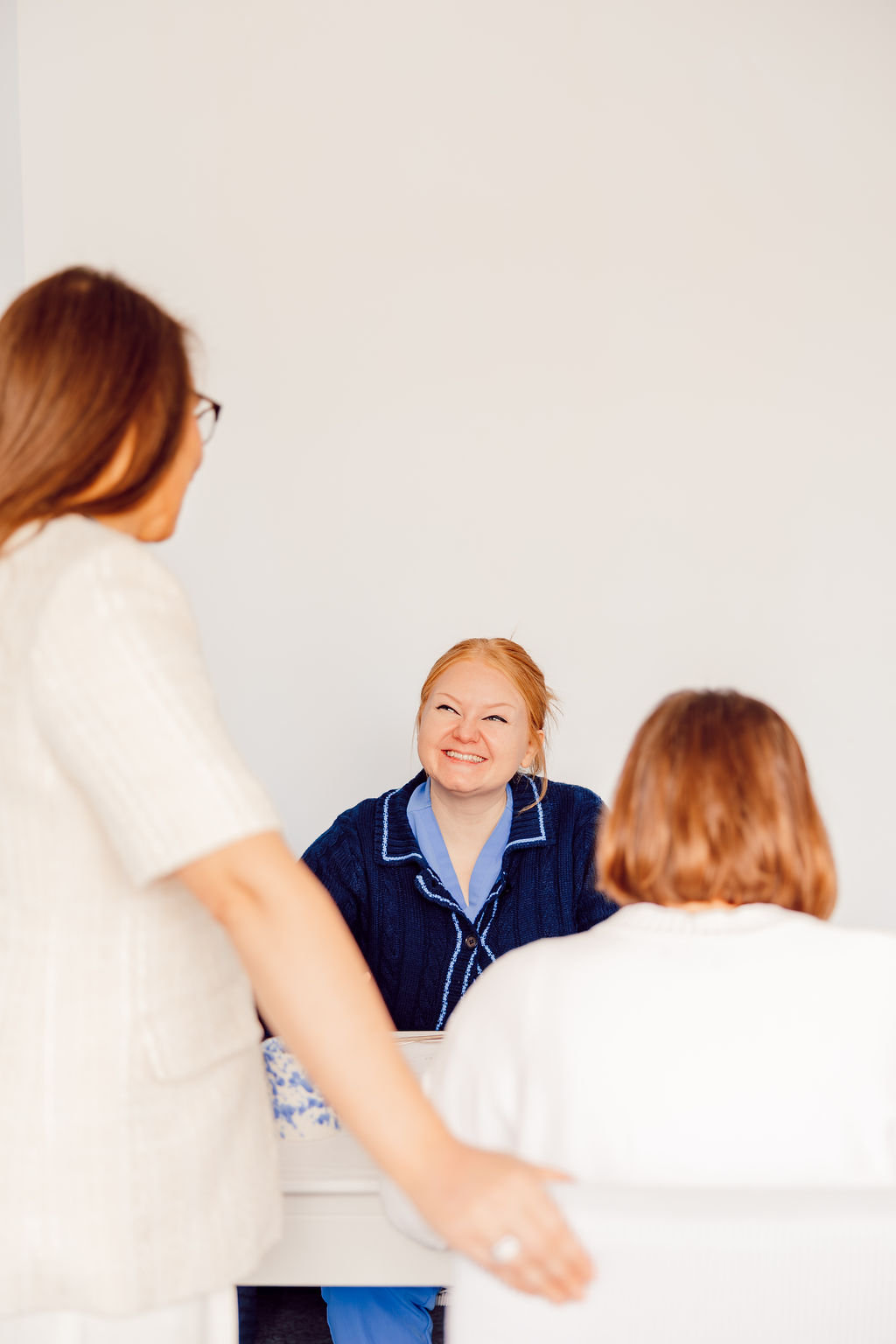 Dr. Megan Baldassarre welcoming a client into the Riverside Psychology office